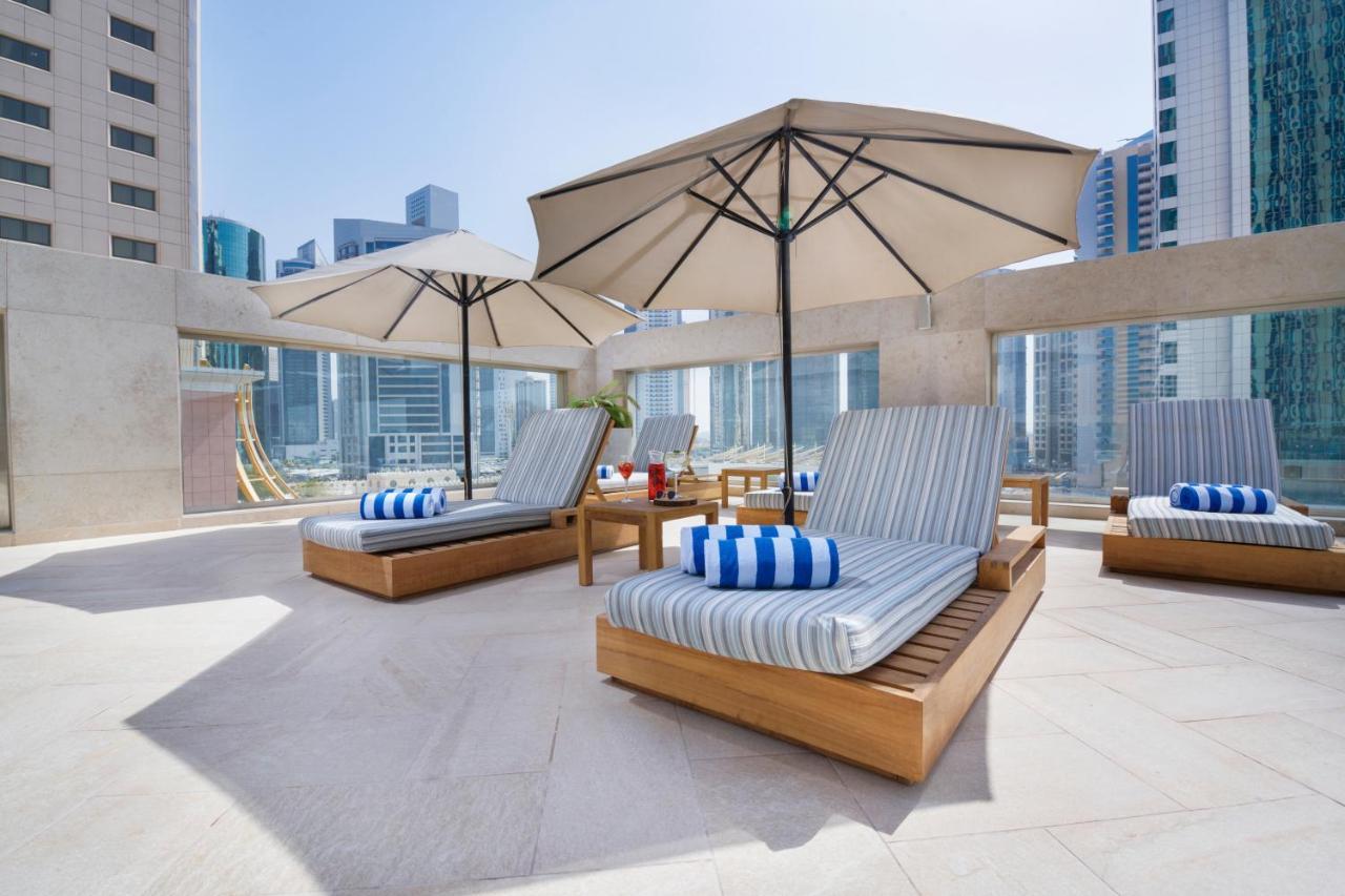 Wyndham Grand Doha West Bay Beach Exterior photo The pool deck at the hotel
